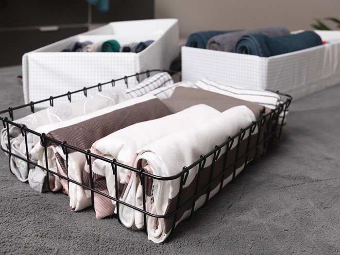 Bacs de rangement contenant des draps.